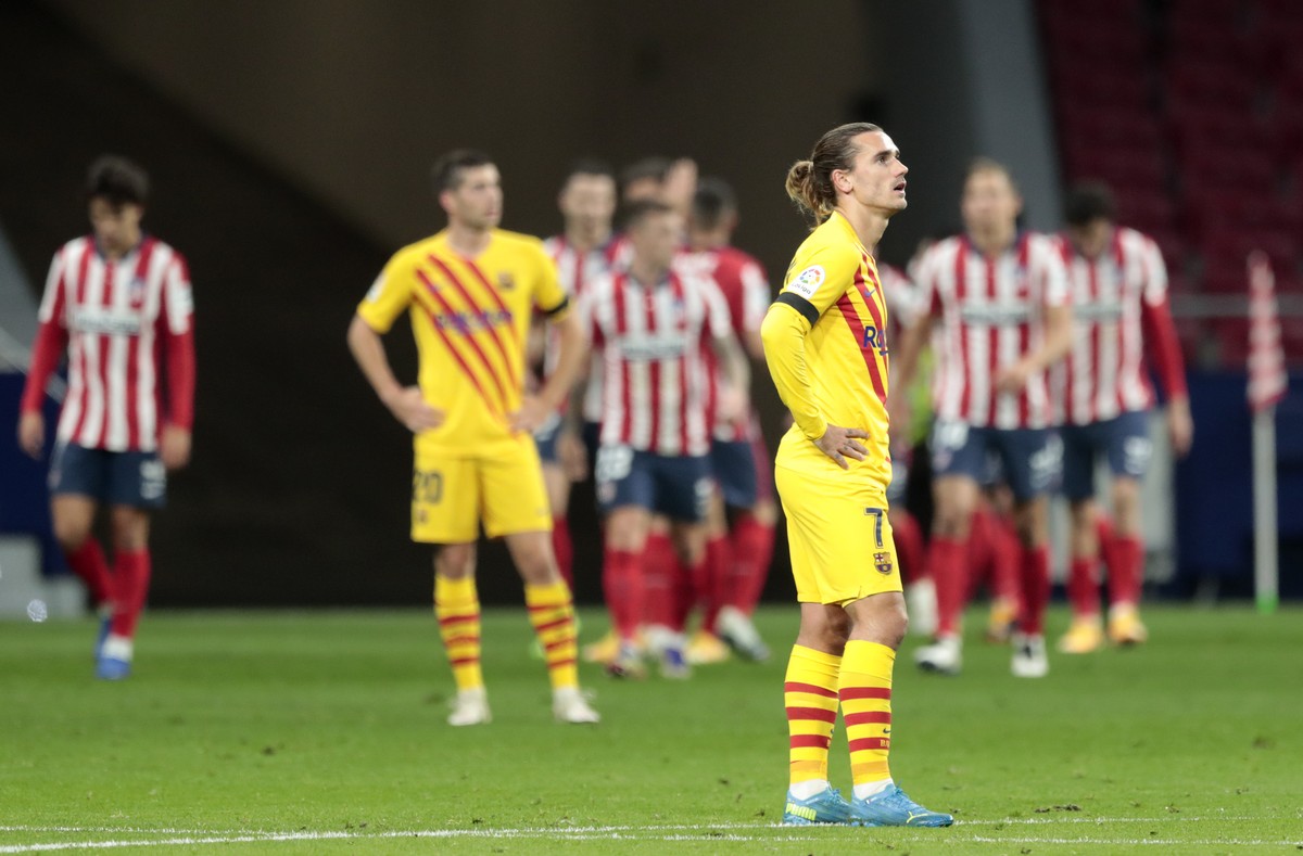 Barcelona's Antoine Griezmann reacts after Atletico Madrid's Yannick Carrasco scored his side's opening goal during the Spanish La Liga soccer match between Atletico Madrid and FC Barce ...