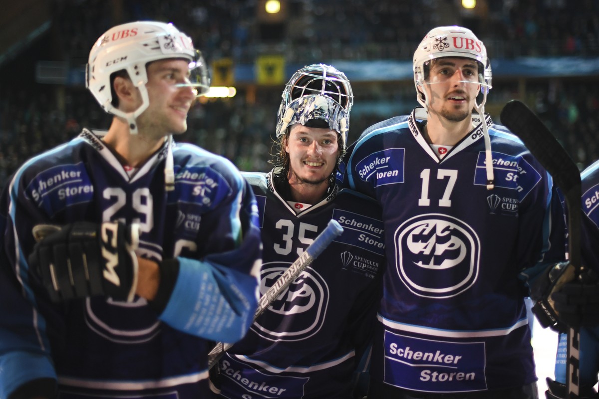 Ambri's Michael Foram goalkeeper Ludovic Waeber, and Ambri's Igor Jelovac, from left, after the game between HC Ambri-Piotta and TPS Turku, at the 93th Spengler Cup ice hockey tournament in  ...