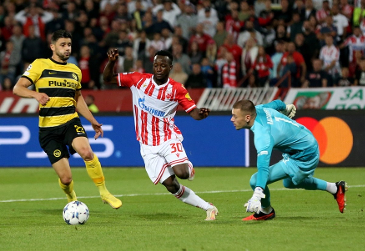 epa10900439 Red Star's Osman Bukari (C) in action against Young Boys' goalkeeper Anthony Racioppi (R) and Loris Benito (L) during the UEFA Champions league group G soccer match between Red S ...