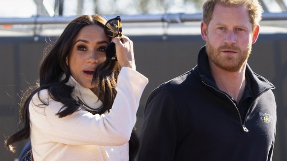 FILE - Prince Harry and Meghan Markle, Duke and Duchess of Sussex visit the track and field event at the Invictus Games in The Hague, Netherlands, Sunday, April 17, 2022. Prince Harry and his wife, Me ...