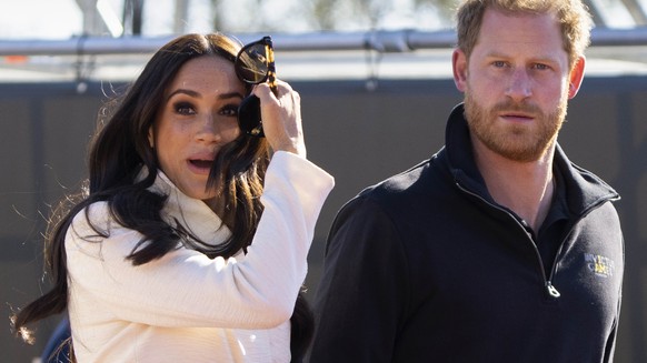 FILE - Prince Harry and Meghan Markle, Duke and Duchess of Sussex attend the athletics event at the Invictus Games in The Hague, Netherlands, Sunday, April 17, 2022. Prince Harry and his wife Me...