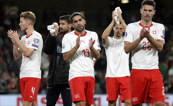 Switzerland&#039;s Ricardo Rodriguez, center and Fabian Schar, right, applaud the supporters at the end of the Euro 2020 group D qualifying soccer match between Ireland and Switzerland at the Aviva st ...