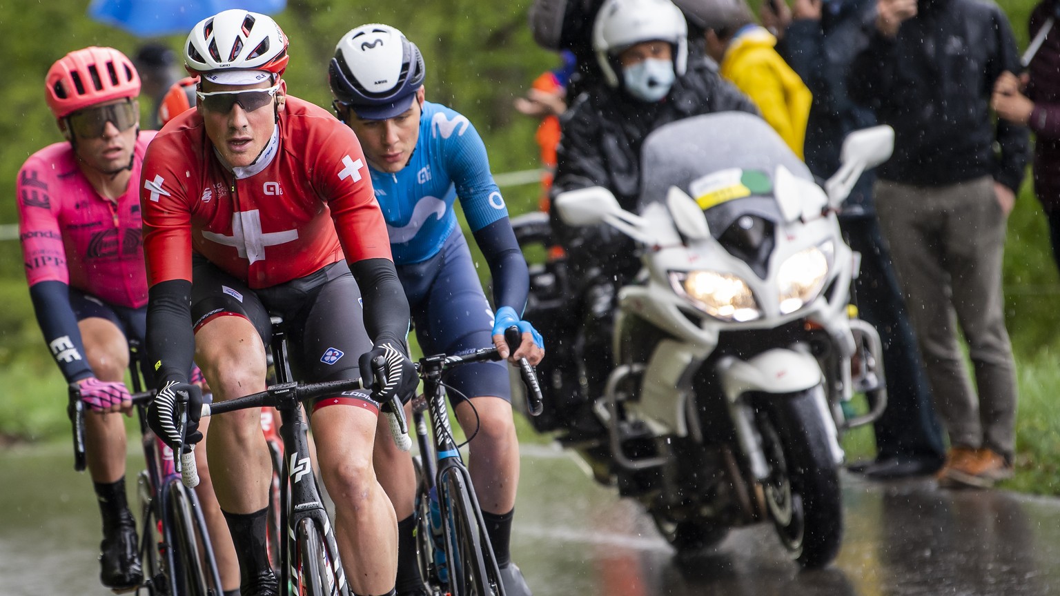 Stefan Bissegger from Switzerland of team EF Education-Nippo, left, Stefan Kueng from Switzerland of team Groupama-FDJ, center, and Johan Jacobs from Switzerland of team Movistar, right, in action dur ...