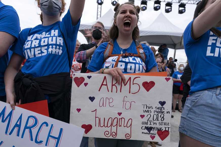 People hold signs in the second March for Our Lives rally in support of gun control Saturday, June 11, 2022, in Washington. The rally is a successor to the 2018 march organized by student protestors a ...