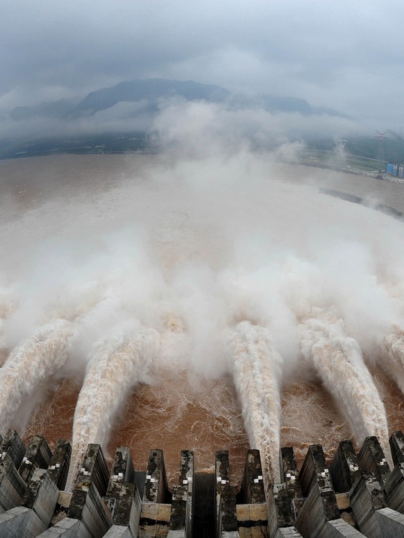 In this photo released by China&#039;s Xinhua news agency, flood water is released from the Three Gorges Dam&#039;s floodgates in Yichang, in central China&#039;s Hubei province, Tuesday, July 20, 201 ...