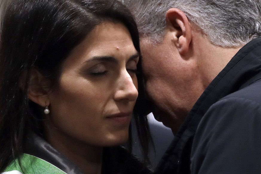 Rome&#039;s Mayor Virginia Raggi, left, listens to Five-Star Movement&#039;s Senator Nicola Morra as she arrives to attend an eucharistic liturgy, at the St. John in Latheran Basilica, in Rome, Thursd ...