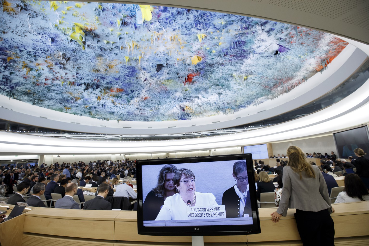 epa07009862 UN High Commissioner for Human Rights Chilean Michelle Bachelet is seen displayed on a screen as she addresses her statement, during the opening of the 39th session of the Human Rights Cou ...