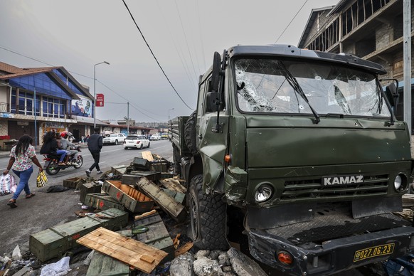 epa11866748 Empty ammunition crates lie on the street next to an abandoned bullet-riddled military truck of the Armed Forces of the Democratic Republic of the Congo (FARDC), in Goma, Democratic Republ ...