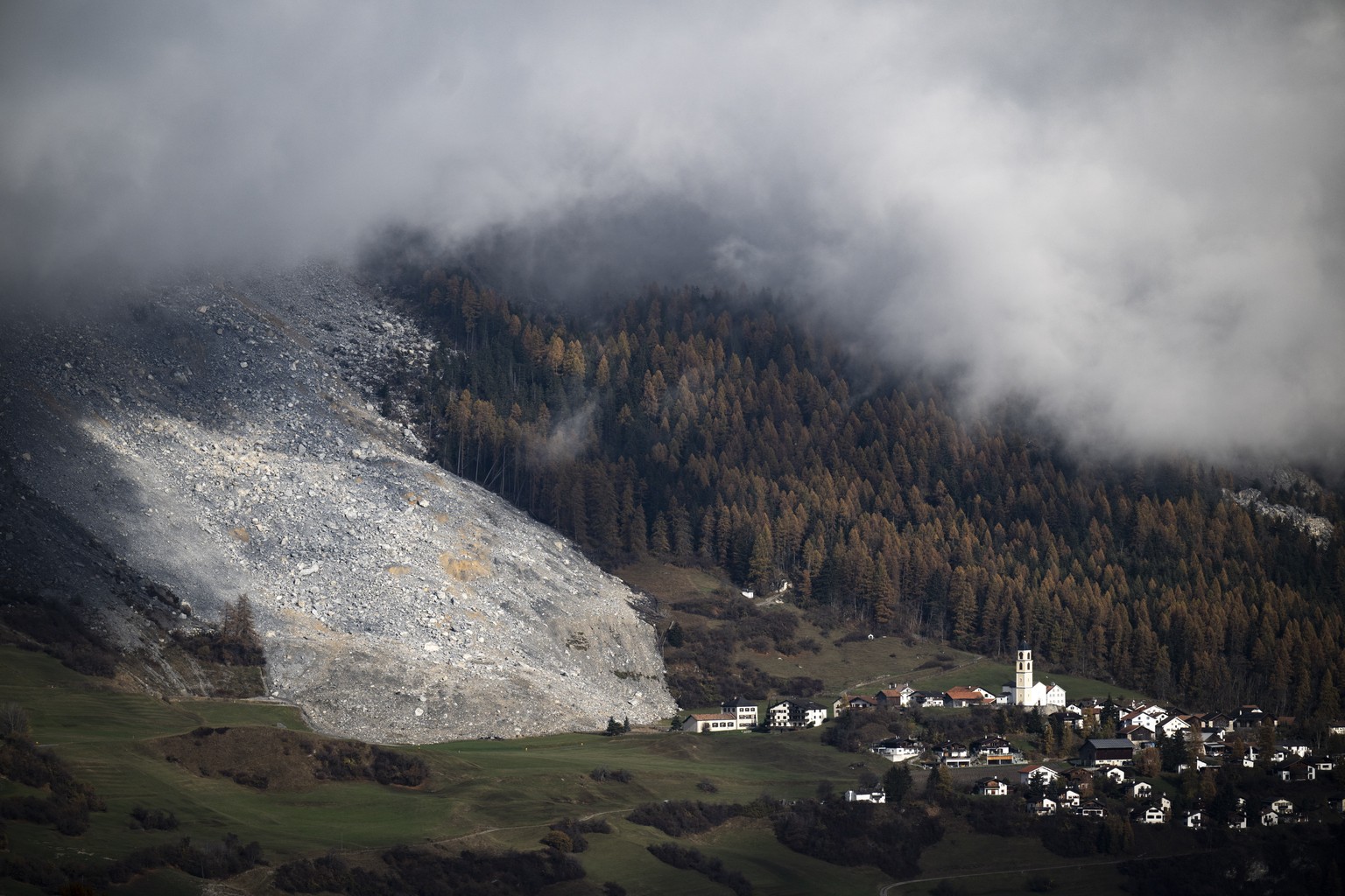 epa11716316 A general view shows a discharge of rocks and debris near the village of Brienz, Brienz-Brinzauls, Switzerland, 12 November 2024. On 15 June 2024, a stream of debris almost reached the vil ...