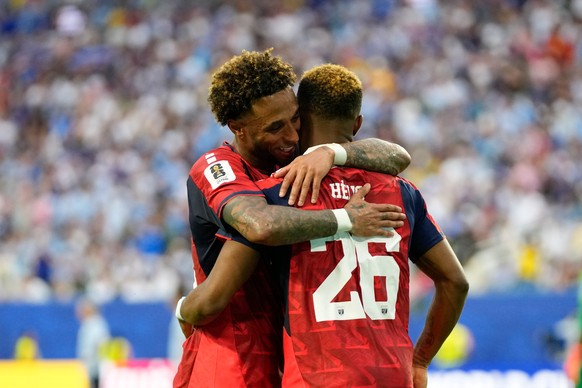 KEYPIX - Cape Verde's Helio Varela, right, celebrates with his teammate Ryan Mendes after scoring his side's second goal against Uruguay during the World Cup Group H soccer match in Miami Ga ...