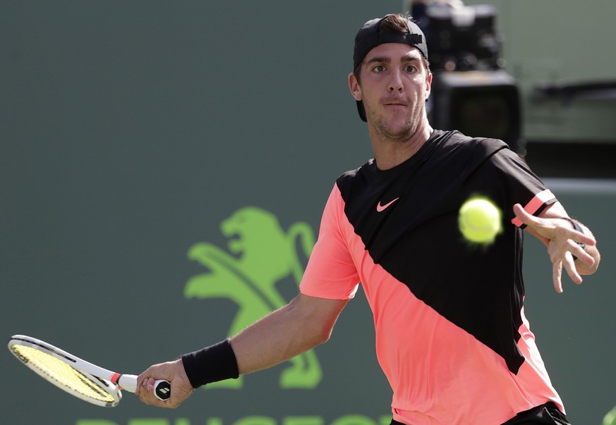 Thanasi Kokkinakis, of Australia, returns to Roger Federer, of Switzerland, during the Miami Open tennis tournament, Saturday, March 24, 2018, in Key Biscayne, Fla. (AP Photo/Lynne Sladky)