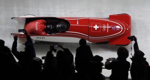 Driver Rico Peter and Simon Friedli of Switzerland take a curve during the two-man bobsled competition at the 2018 Winter Olympics in Pyeongchang, South Korea, Sunday, Feb. 18, 2018. (AP Photo/Wong Ma ...