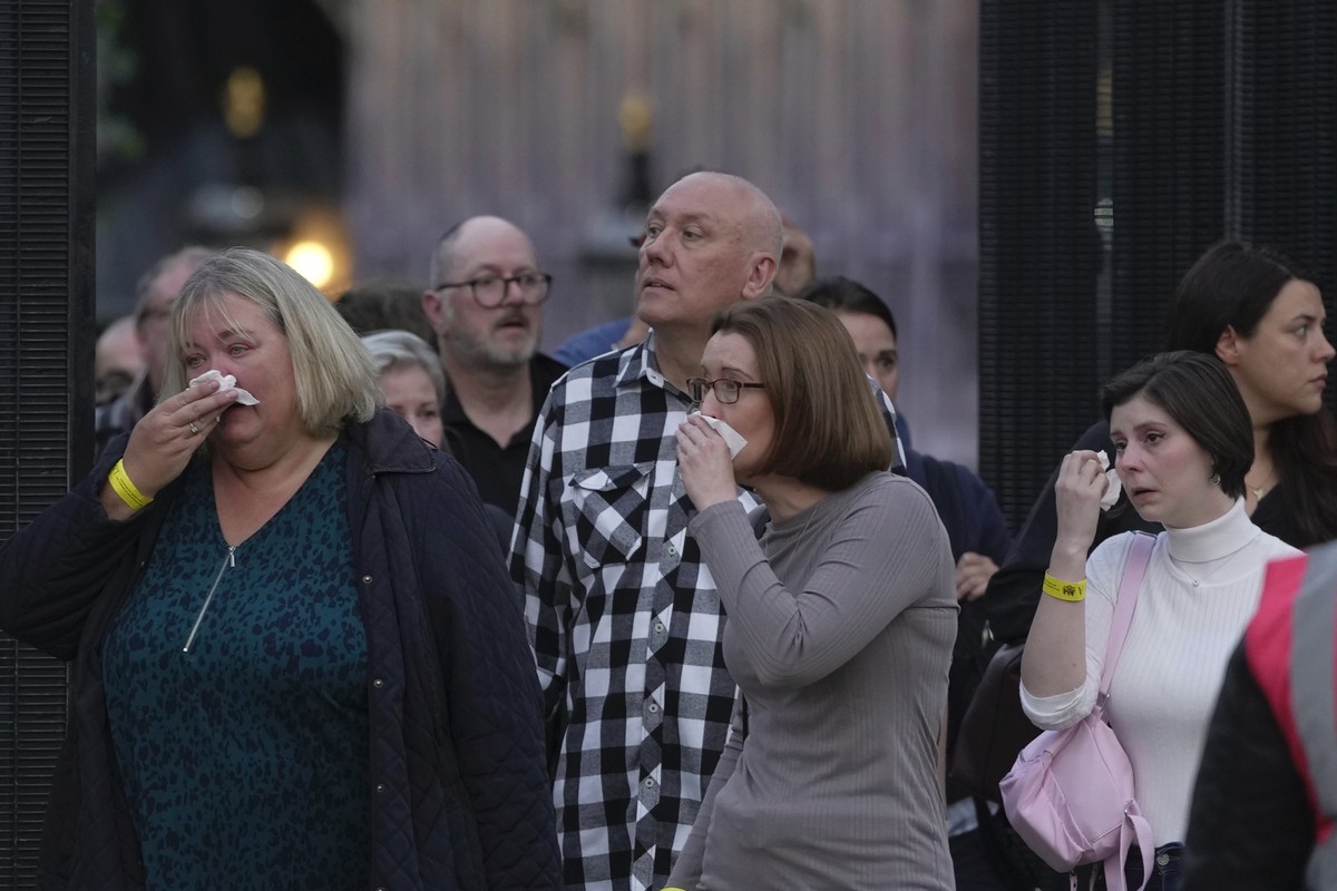 People cry as they leave the Queen Elizabeth II's lying in state in London, Wednesday Sept. 14, 2022. The Queen will lie in state in Westminster Hall for four full days before her funeral on Mond ...