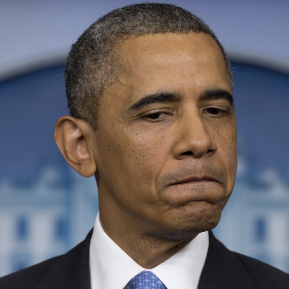 FILE - In this Friday, July 19, 2013 file photo, President Barack Obama pauses as he speaks about the fatal shooting of Trayvon Martin by George Zimmerman, during the daily news briefing at the White  ...