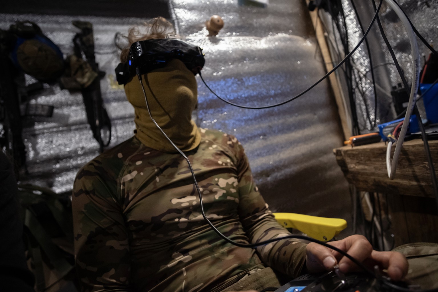 epa12256338 Ukrainian drone pilots belonging to the 20th Lyubart Brigade of the 1st Corps of the National Guard Azov conduct an FPV drone strike mission from inside their trench on the Toretsk frontli ...