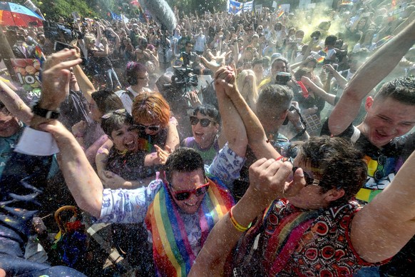 epaselect epa06330195 People celebrate after the announcement of the same-sex marriage postal survey result in front of the State Library of Victoria in Melbourne, Australia, 15 November 2017. Austral ...