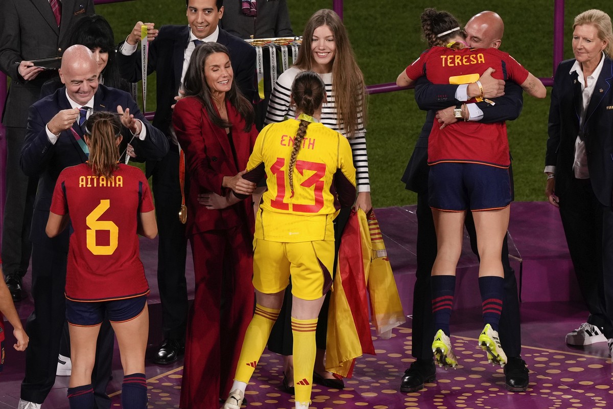President of Spain's soccer federation, Luis Rubiales, right, embraces Teresa Abelleira on the podium following Spain's win in the final of Women's World Cup soccer against England at S ...