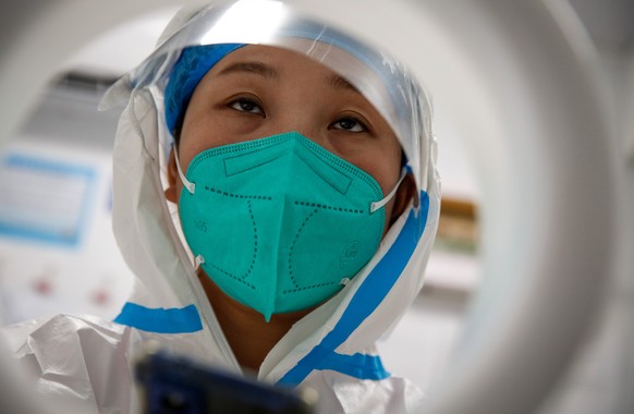epa10156572 A health worker looks on from a COVID-19 test site in Beijing, China, 03 September 2022. China has put the southwestern city of Chengdu, home to 21 million people on lockdown as the countr ...