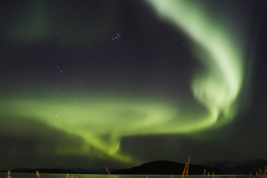 FILE - This Oct. 5, 2015 file photo shows the aurora borealis, or Northern Lights, over the Norwegian town of Harstad. Tourism to destinations like Norway, Iceland and Alaska has been growing in popul ...