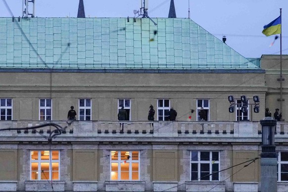 Police officers stand on the balcony of the Philosophical Faculty of Charles University in the center of Prague, Czech Republic, on Thursday, December 1.  August 21, 2023. Czech police say a shooting in central Prague has claimed the lives of…