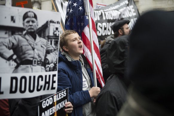 epa05735636 Protestors demonstrate near the parade route, where Donald J. Trump will walk after taking the oath of office, as he is sworn in as the 45th President of the United States in Washington, D ...