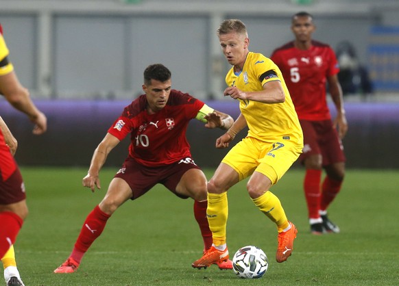 Switzerland&#039;s Granit Xhaka, left, and Ukraine&#039;s Olexandr Zinchenko challenge for the ball during the UEFA Nations League soccer match between Ukraine and Switzerland at the Arena Lviv stadiu ...