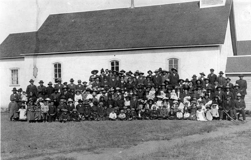 epa09302128 A historical photo dated .ca 1910 provided by the Provincial Archives of Saskatchewan (issued on 26 June 2021) shows the Marieval Mission Church and its congregation as it stood next to th ...