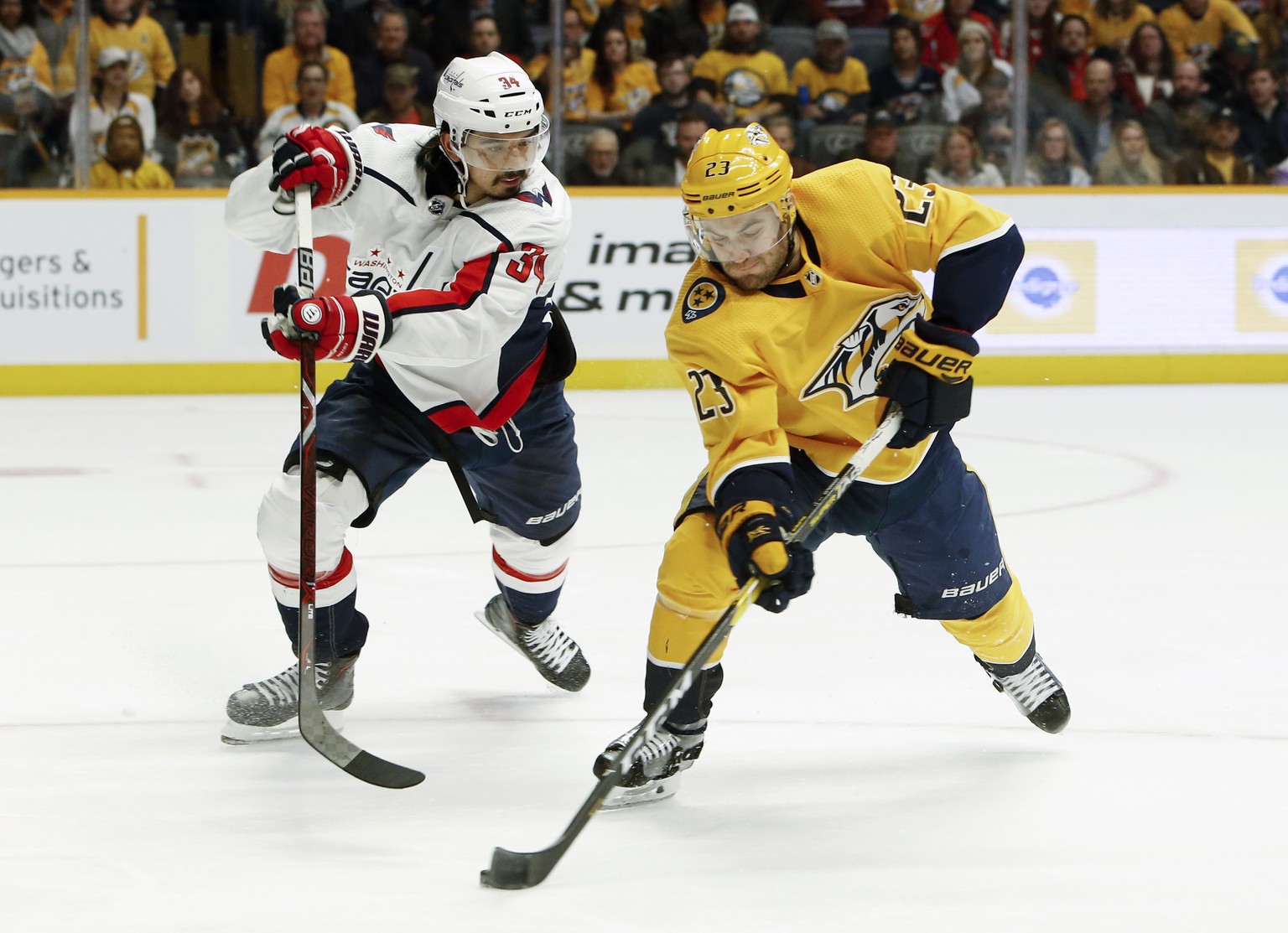 Nashville Predators center Rocco Grimaldi (23) scores a goal on a backhand shot past Washington Capitals defenseman Jonas Siegenthaler (34), of Switzerland, during the second period of an NHL hockey g ...