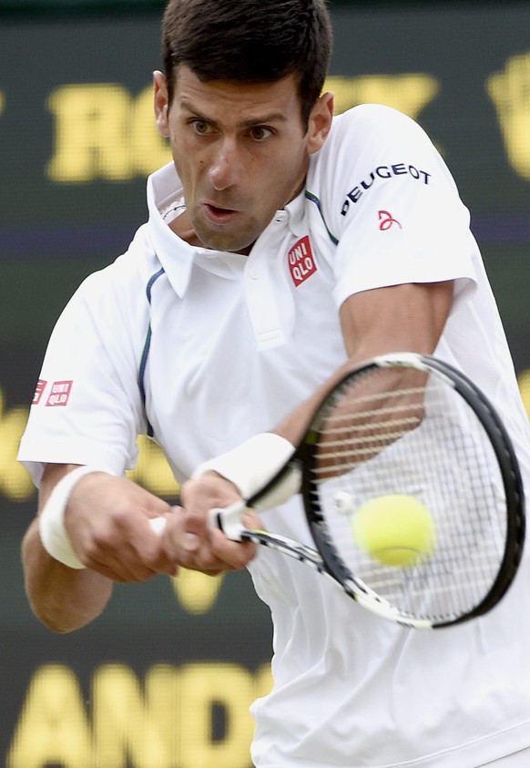 epa04834466 Novak Djokovic of Serbia in action against Kevin Anderson of South Africa during their fourth round match for the Wimbledon Championships at the All England Lawn Tennis Club, in London, Br ...