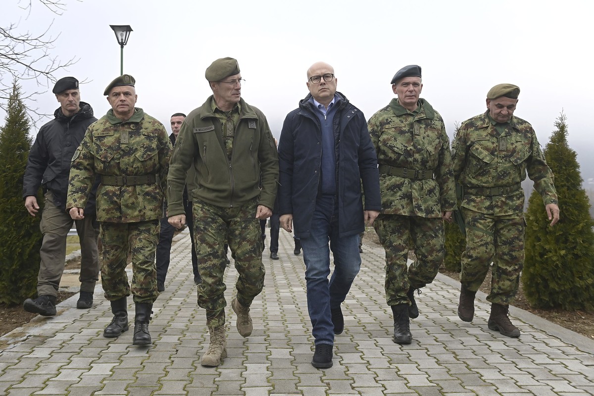 In this photo provided by the Serbian Defense Ministry Press Service, Serbia Defense Minister Milos Vucevic, center, speaks with Serbian army chief of staff Milan Mojsilovic, center left, at the army  ...