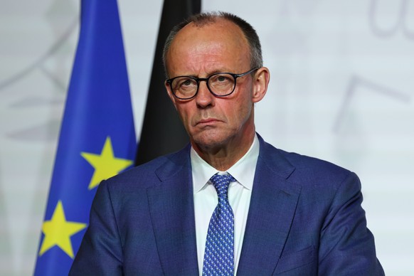 German Chancellor Friedrich Merz listens after the signing of the declaration on deploying post-ceasefire force in Ukraine during the 'Coalition of the Willing' summit on security guarantees ...