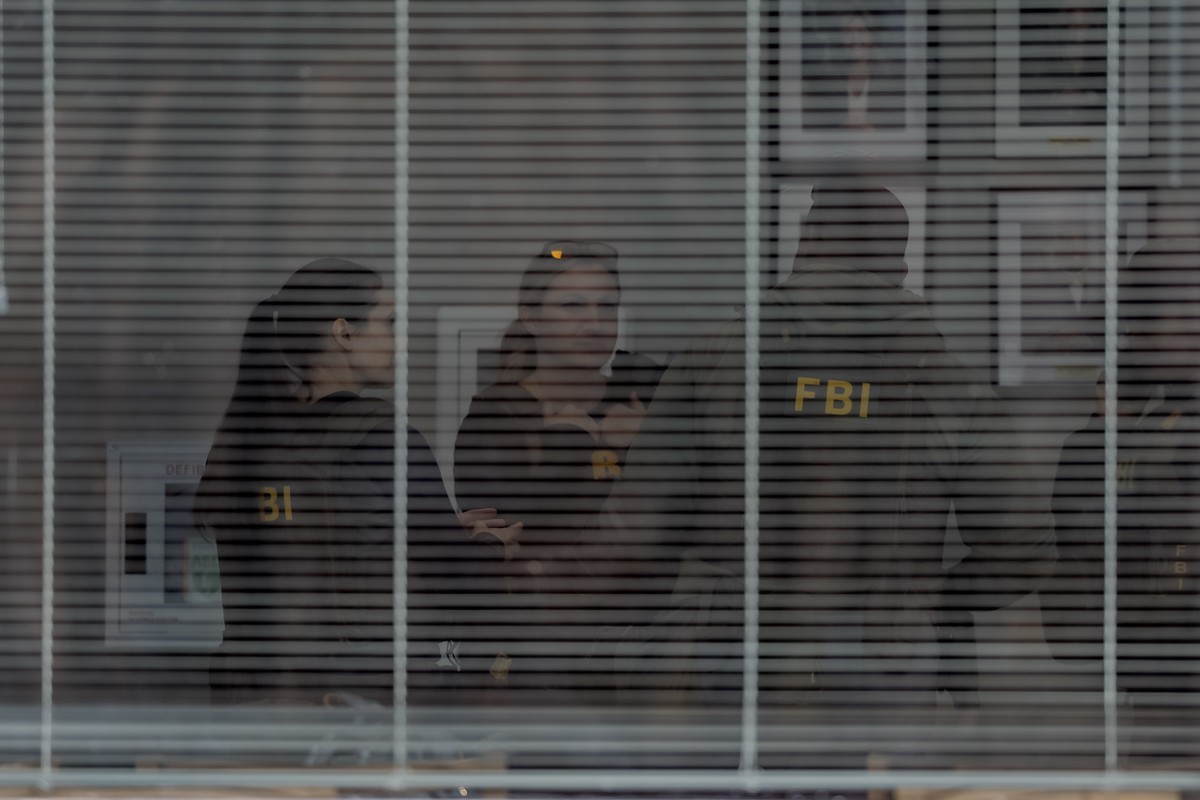 epa12689305 Federal Bureau of Investigation (FBI) agents gather inside the building as the FBI conducts a 'court-ordered search warrant' at the Fulton County Department of Registration and E ...