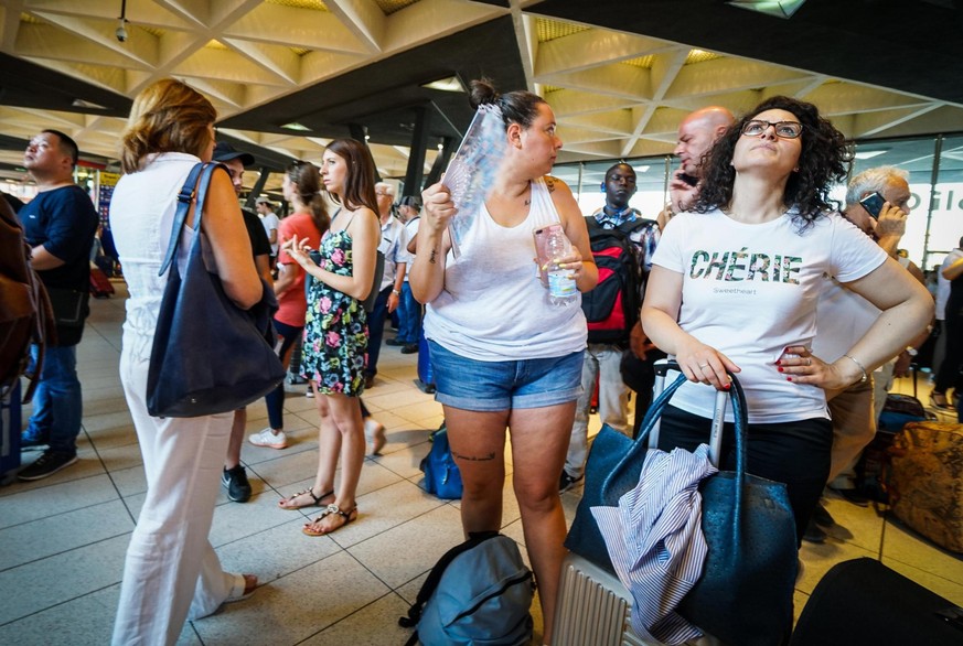 Passengers check train times at Naples&#039; Central station, southern Italy, Monday, July 22, 2019. A suspected arson fire has forced cancellations of at least 42 high-speed trains in Italy on the he ...