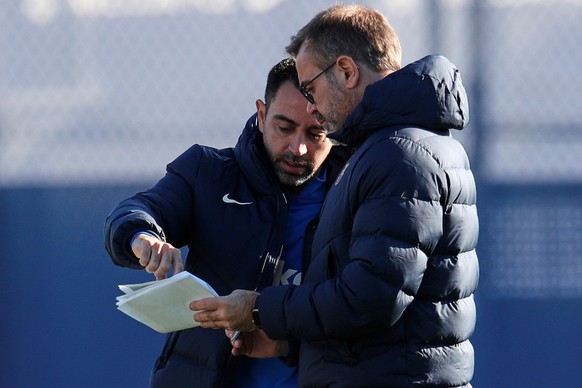 epa09635754 FC Barcelona&#039;s head coach Xavi Hernandez (L) and his assistant Oscar Hernandez are seen during a training session of the team at Joan Gampero sports city in Barcelona, Spain, 11 Decem ...