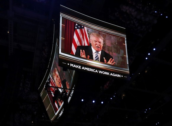 U.S. Republican Presidential Nominee Donald Trump is shown on video monitors as he speaks live to the crowd from New York at the Republican National Convention in Cleveland, Ohio, U.S. July 19, 2016.  ...