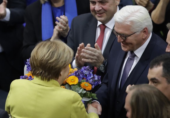 Newly elected German President Frank-Walter Steinmeier, right, is congratulated by German Chancellor Angela Merkel when a German parliamentary assembly came together to elect the country&#039;s new pr ...