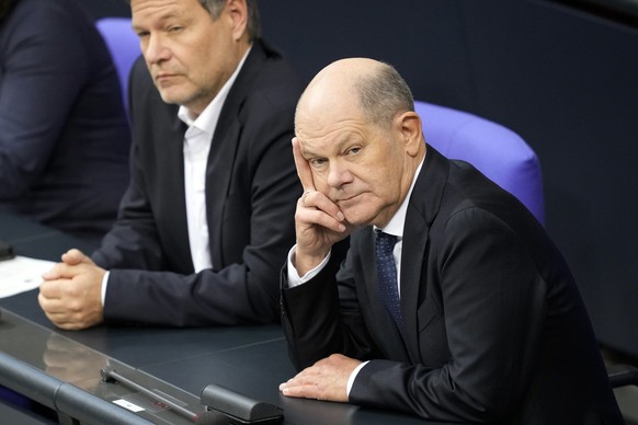 German Chancellor Olaf Scholz, right, listens to the speech of Friedrich Merz, German opposition leader and chairman of the Christian Democratic Union (CDU) party, speaking during a session of the Ger ...