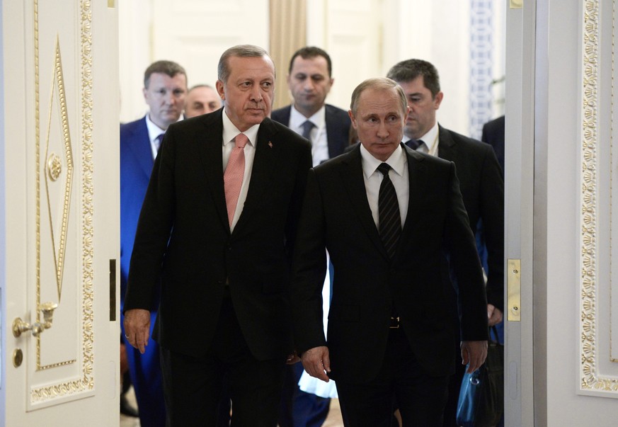 epa05467781 Turkish President Recep Tayyip Erdogan (L) and Russian President Vladimir Putin (R) walk to attend Russian-Turkish talks during a working breakfast at the Constantine palace in St. Petersb ...