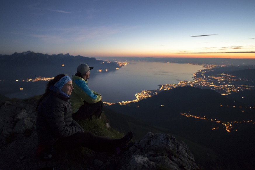 Anais, left, and Anthony, right, watch the sunset from the Dent de Jaman mountain (1875m) above Montreux, Switzerland, with Lake Geneva in the background, on Sunday, June 11, 2017. (KEYSTONE/Anthony A ...