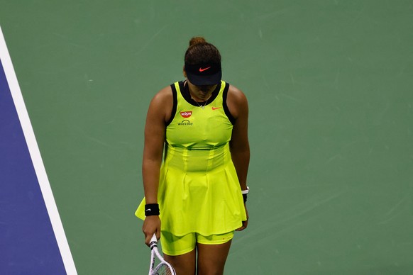epa09446680 Naomi Osaka of Japan walks with her head down after losing a point against Leylah Fernandez of Canada during their match on the fifth day of the US Open Tennis Championships at the USTA Na ...