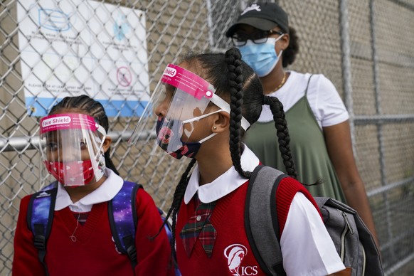 FILE - In this Sept. 9, 2020, file photo, students wear protective masks as they arrive for classes at the Immaculate Conception School while observing COVID-19 prevention protocols in The Bronx borou ...