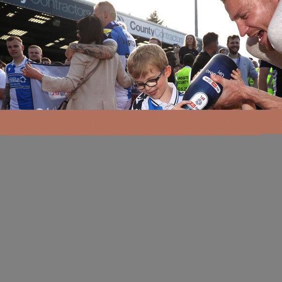 IMAGO / PA Images

Bristol Rovers v Scunthorpe United - Sky Bet League Two - Memorial Stadium Bristol Rovers Sam Finlay has champagne poured over him by his children to celebrate promotion to the Sky  ...