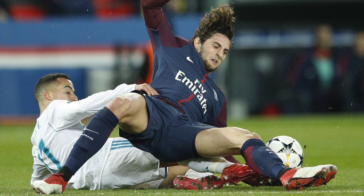 Real Madrid&#039;s Lucas Vazquez, left, stops PSG&#039;s Adrien Rabiot during the round of 16, 2nd leg Champions League soccer match between Paris Saint-Germain and Real Madrid at the Parc des Princes ...