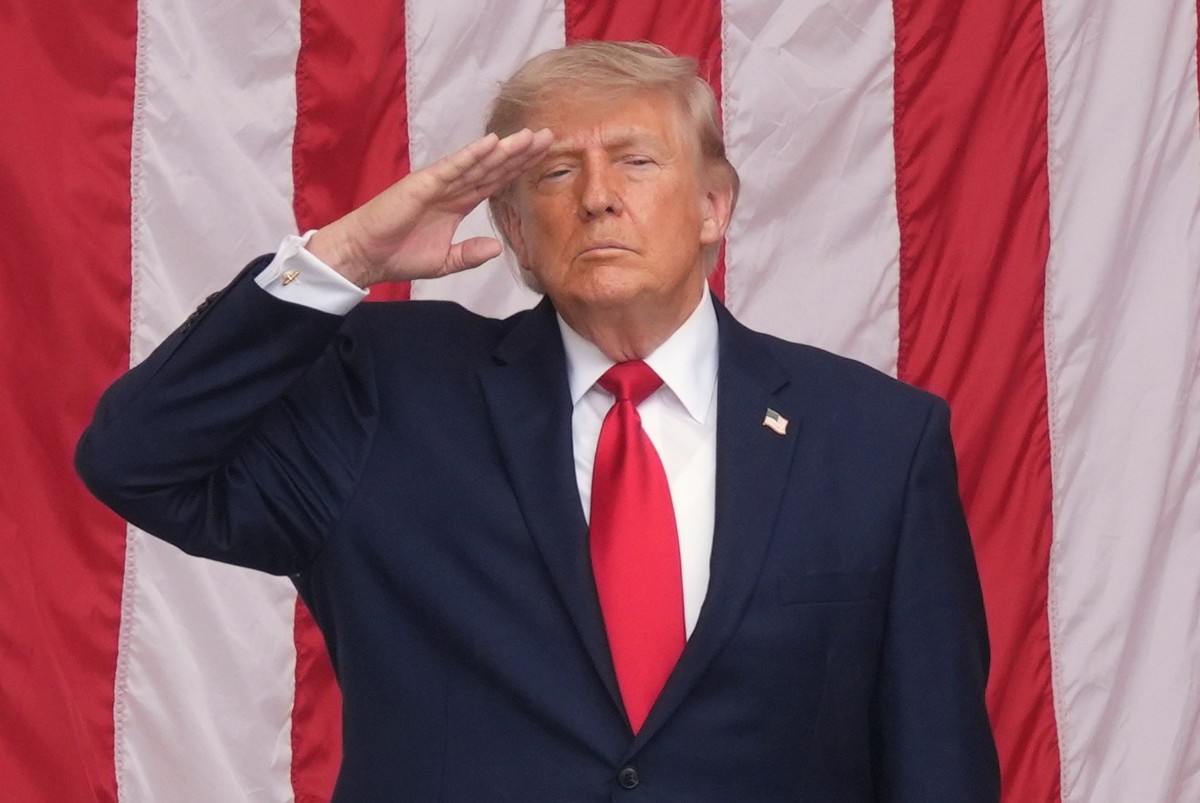 President Donald Trump salutes during the playing of taps at the 158th National Memorial Day Observance coinciding with the nation's 250th anniversary, at the Memorial Amphitheater in Arlington N ...