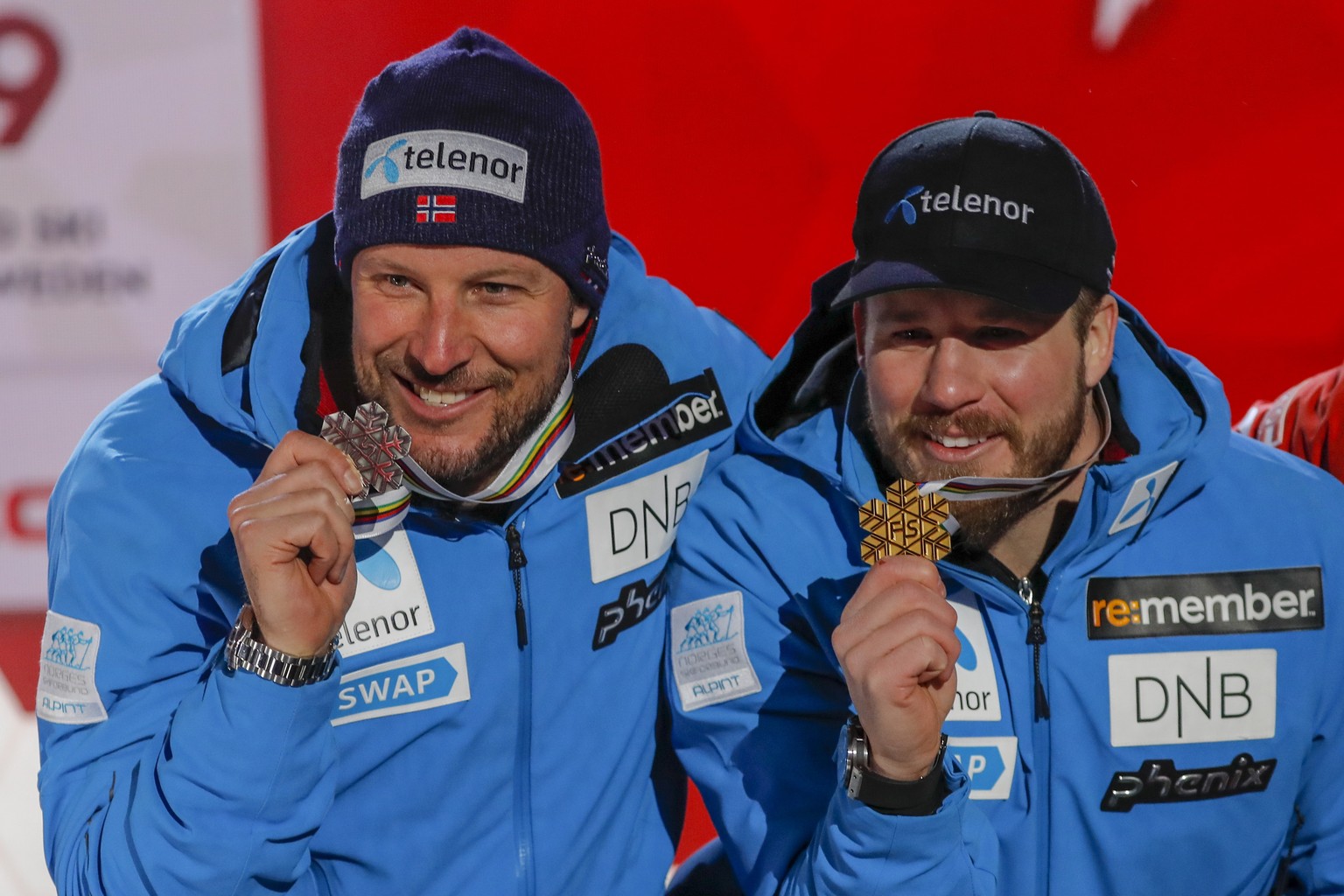 epa07356480 Second placed Aksel Lund Svindal of Norway (L) and first placed Kjetil Jansrud of Norway (R) pose with their medals during the medal ceremony for the men&#039;s Downhill race at the FIS Al ...