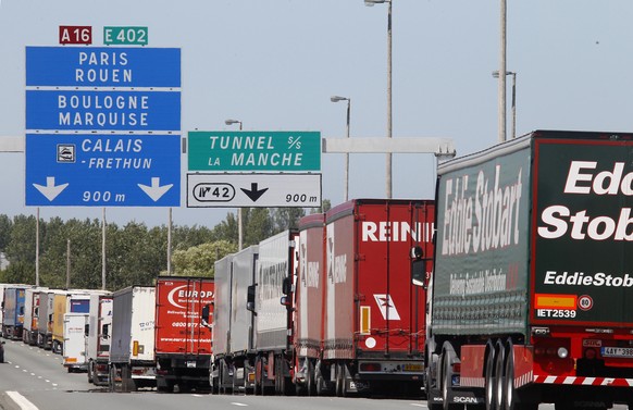 Trucks are stuck in a traffic jam on a highway leading to the Channel tunnel after striking workers invaded the Eurotunnel train tracks in Calais, northern France, in a protest against job cuts, Tuesd ...