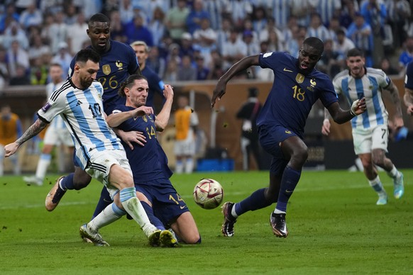 Argentina&#039;s Lionel Messi shots by France&#039;s Adrien Rabiot during the World Cup final soccer match between Argentina and France at the Lusail Stadium in Lusail, Qatar, Sunday, Dec. 18, 2022. ( ...
