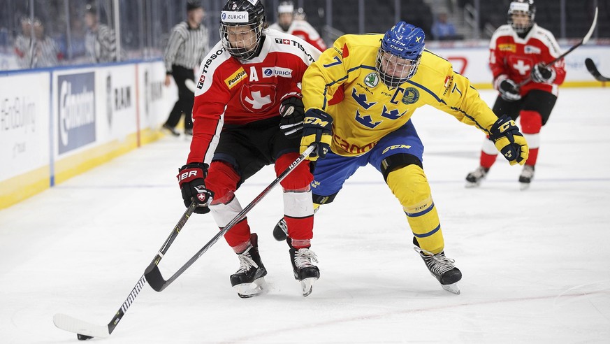 Sweden&#039;s Tobias Bjornfot (7) pursues Switzerland&#039;s Simon Knak (8) during the third period of a Hlinka Gretzky Cup game in Edmonton, Alberta, Tuesday, Aug. 7, 2018. (Codie McLachlan/The Canad ...