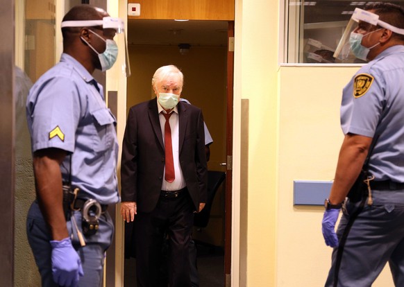 epa08624150 A handout photo made available by the UN International Residual Mechanism for Criminal Tribunals (UN-IRMCT) shows Bosnian Serb former general Ratko Mladic (C) arriving for his appeal again ...