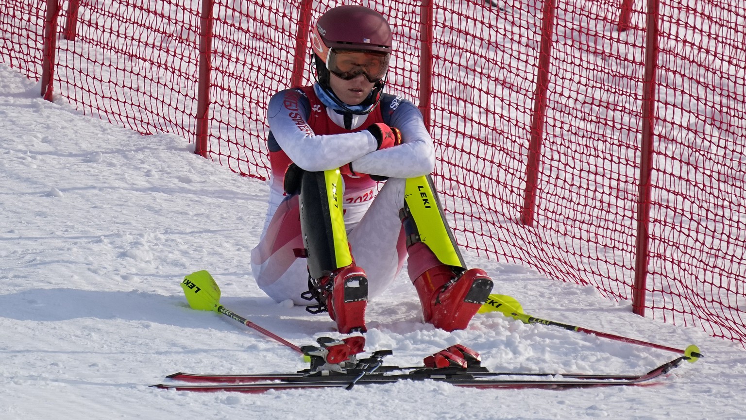 Mikaela Shiffrin, of the United States sits on the side of the course after skiing out in the first run of the women&#039;s slalom at the 2022 Winter Olympics, Wednesday, Feb. 9, 2022, in the Yanqing  ...